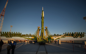 The Soyuz rocket is erected into position after being rolled out to the launch pad by train, on Sunday, October 21, 2012, at the Baikonur Cosmodrome in Kazakhstan.